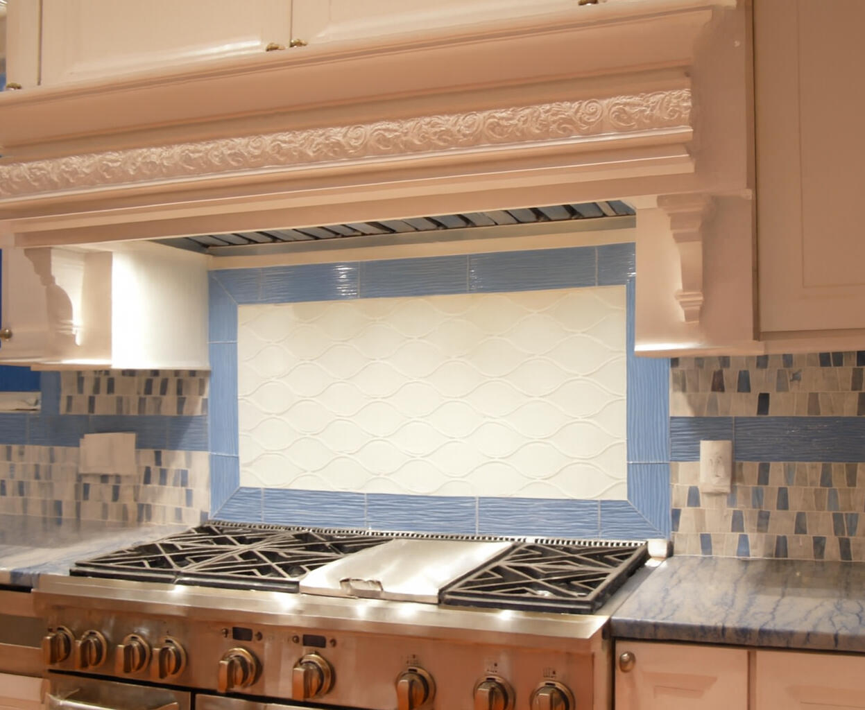 Sophisticated Luminous Subway Tile Backsplash with Dynamic Blue Glass Herringbone Accents for a Vibrant Seaside Vibe