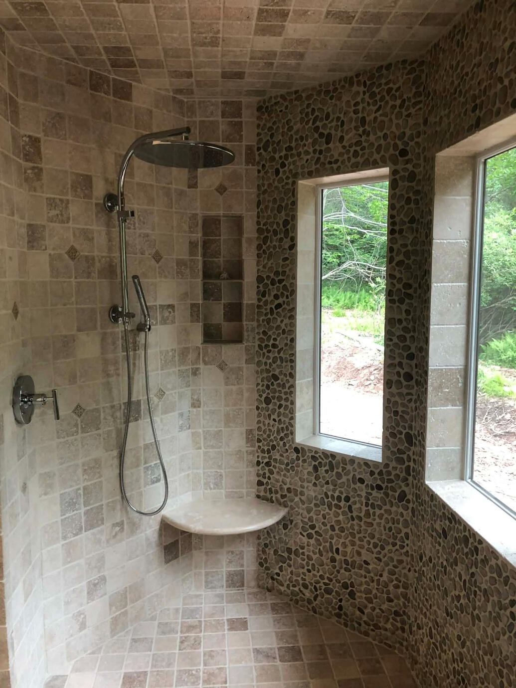 Rustic Travertine and Pebble Shower Wall